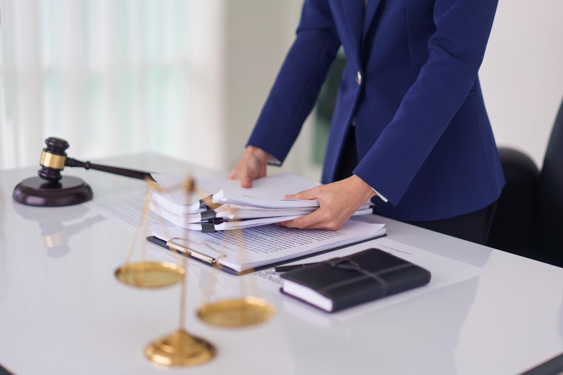 Lawyer woman hold document and working about business contract with legal agreement in legal office